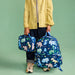 Boy holding a Dino Fossils Rodgers Lunchbox and a Kane Backpack