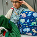 Boy sitting next to a Dino Fossils Kane Backpack