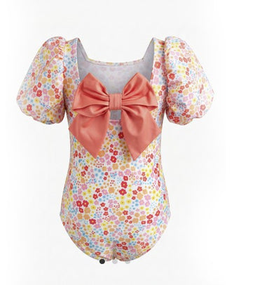 Floral swimsuit with a large bow on a white background