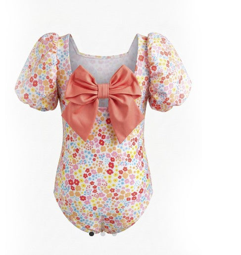 Floral swimsuit with a large bow on a white background