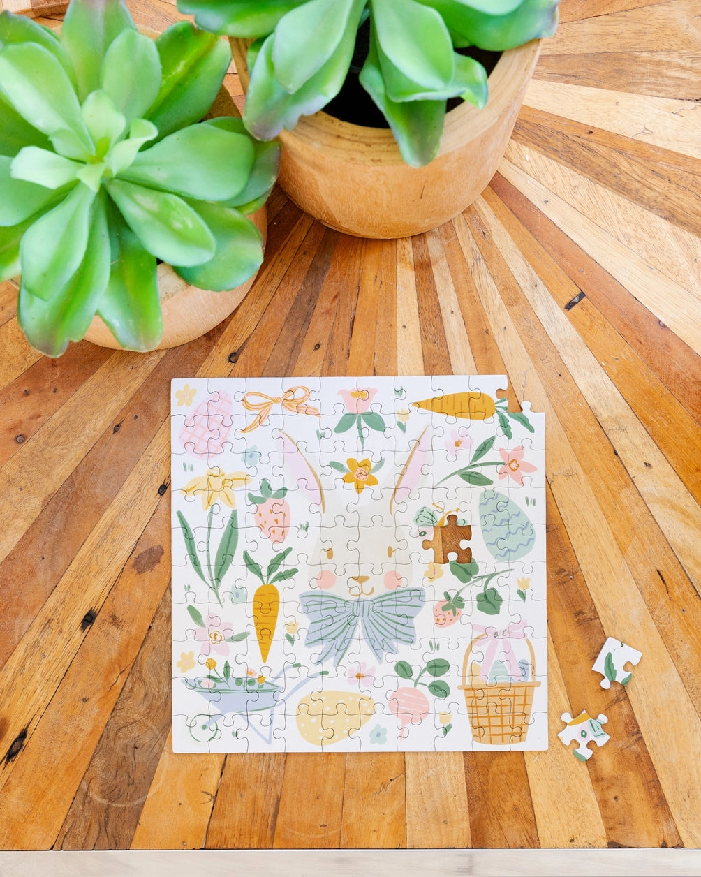 Jigsaw puzzle with nature-themed design on a wooden surface with plants.