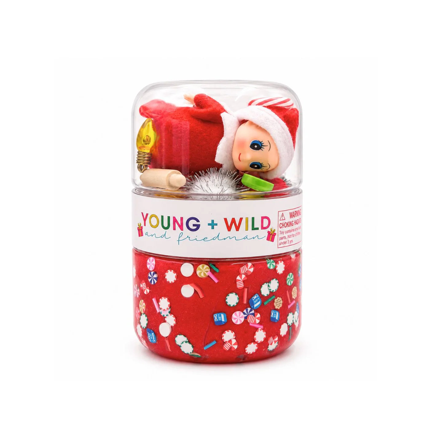 Red sensory dough jar with a clear top compartment holding an elf figure and festive play treasures from Young Wild and Friedman for imaginative Christmas play.