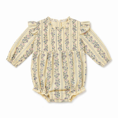 A baby long-sleeve romper in a pale yellowish-beige fabric with vertical stripes and a delicate pink and green floral pattern, featuring ruffled shoulders and a ruffled leg opening.