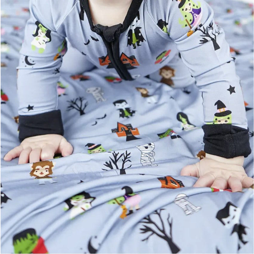 up close of grey bamboo zipper romper with cute "monster mash" print