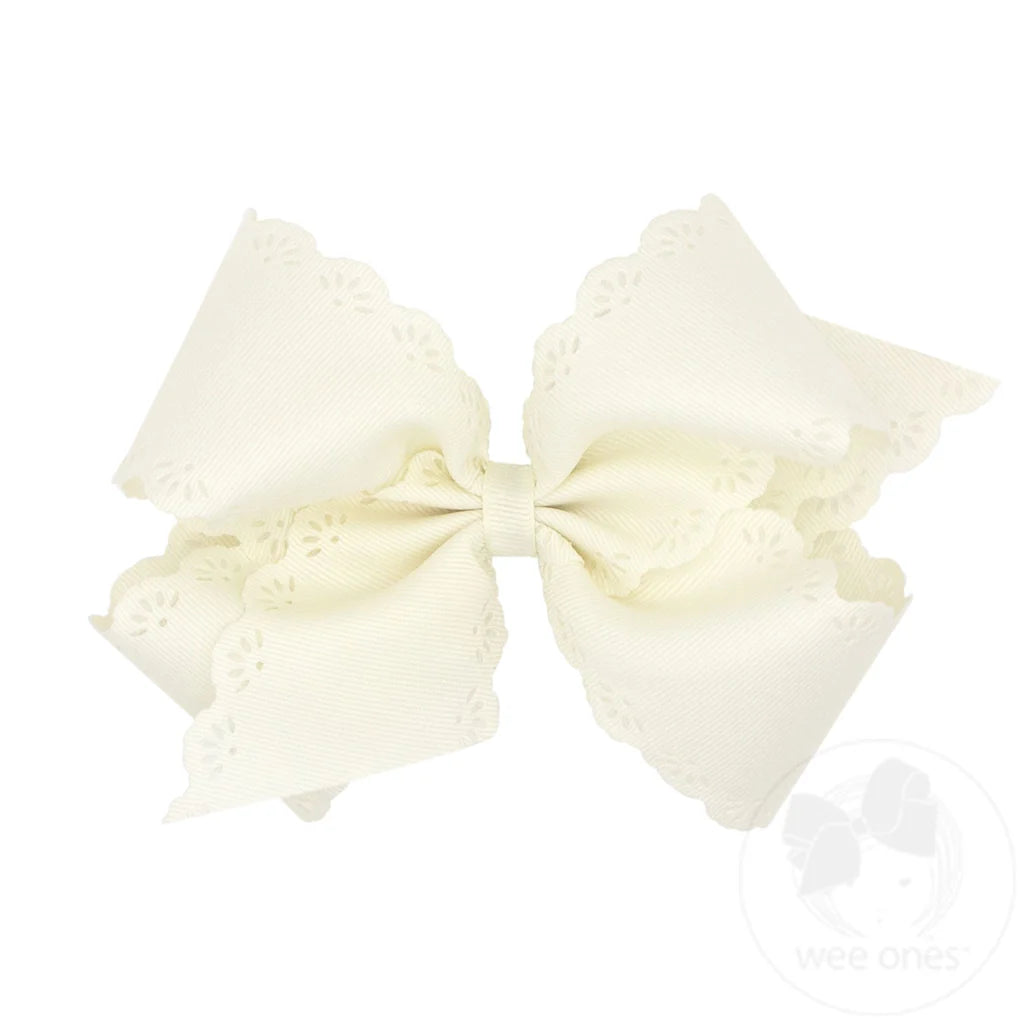 Large cream-colored bow with lace details on a white background