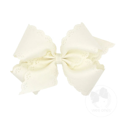 Large cream-colored bow with lace details on a white background