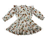 A white tiered ruffle dress with a long-sleeve puff sleeve and a smocked waist, featuring an all-over western print of brown horses, green cacti, and orange horseshoes.