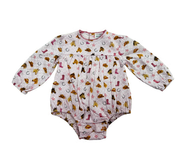 A baby long-sleeve romper in a white fabric with a colorful western-themed print featuring boots, horseshoes, stars, and cowboy hats, displayed flat against a white background.