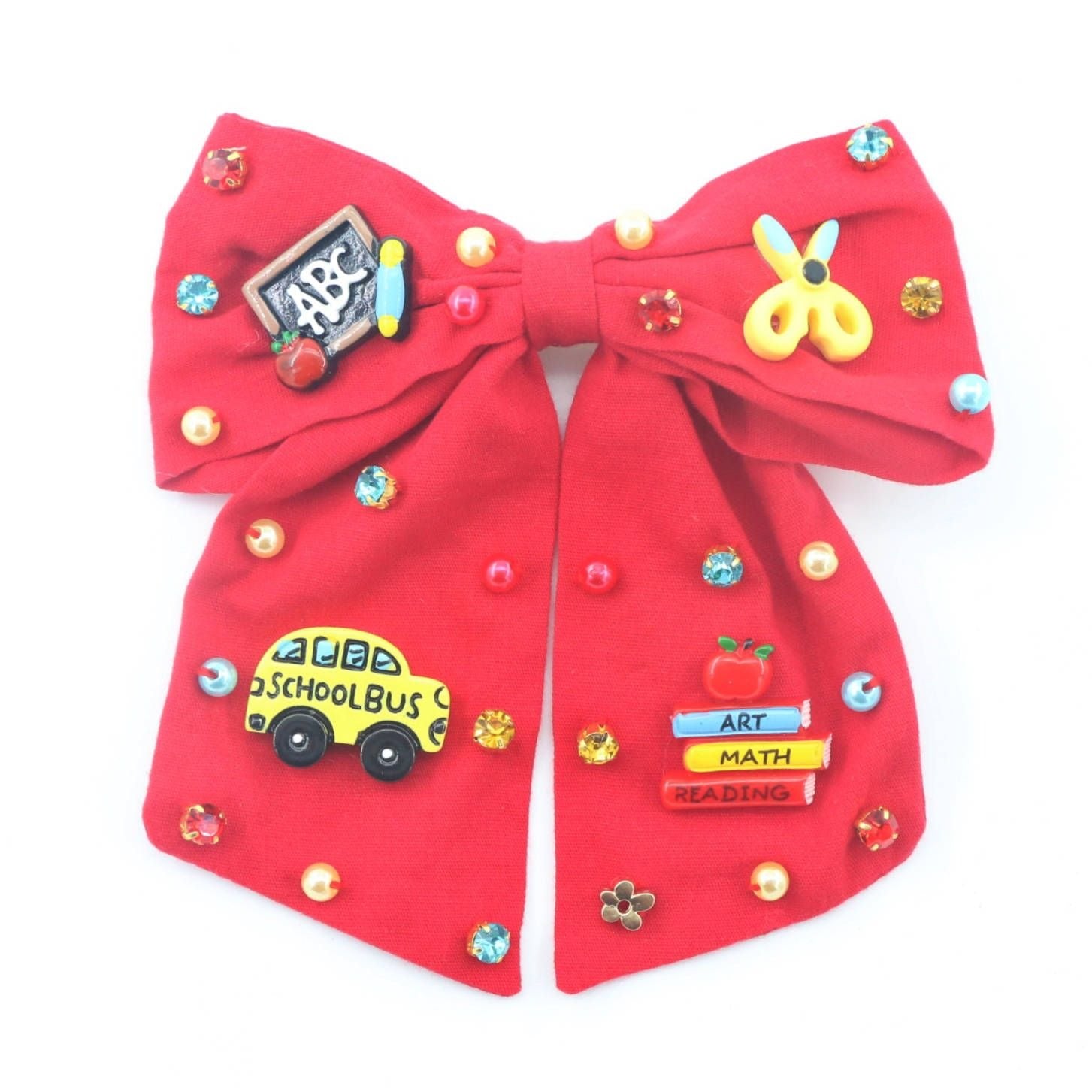 Red bow with educational-themed pins on a white background