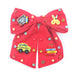 Red bow with educational-themed pins on a white background