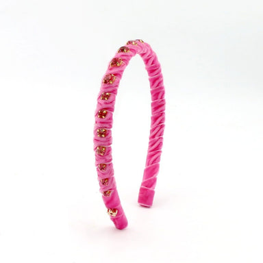 Pink headband with gold accents on a white background