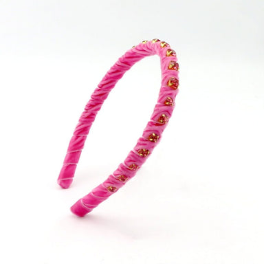 Pink headband with gold heart shapes on a white background