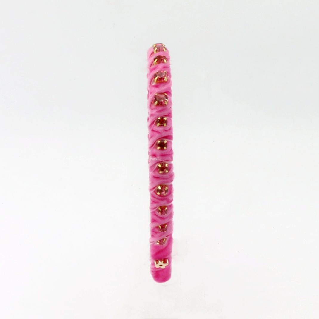A single pink beaded bracelet with metallic gold accents, shown vertically against a plain white background.