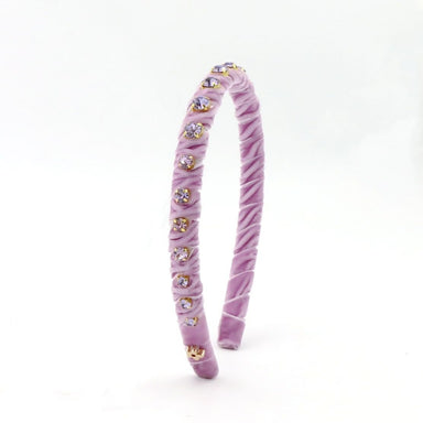 A lavender velvet headband decorated with small gold and clear rhinestone accents, standing upright on a white background.