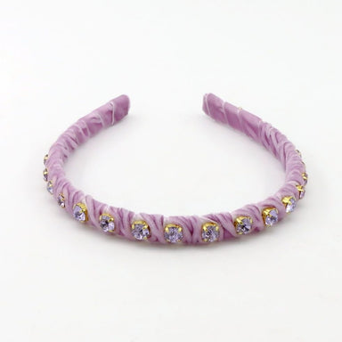 A lavender purple fabric headband with ruched rosettes and small gold-rimmed clear rhinestones, displayed on a clean white background.