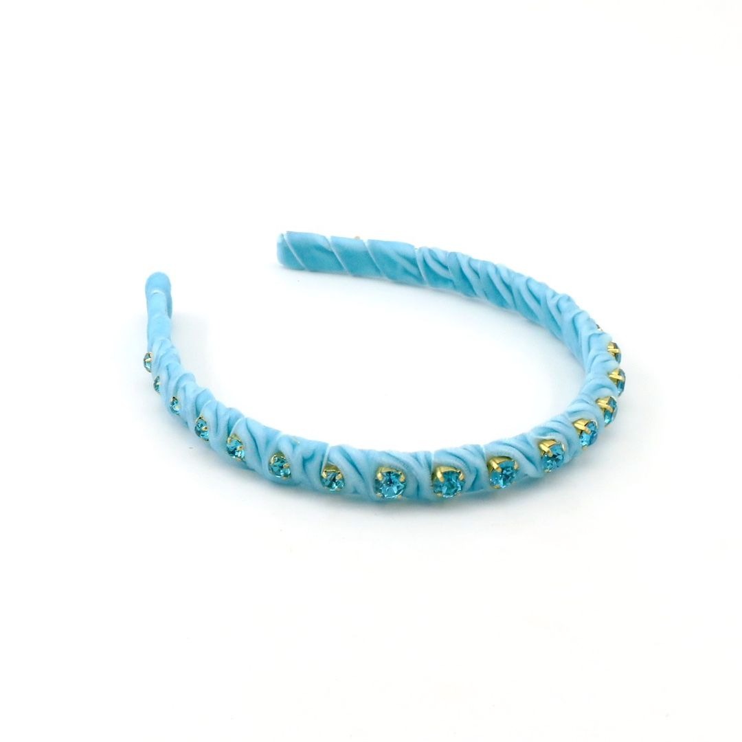 A light blue twisted elastic headband embellished with small rhinestone clusters, shown on a plain white background.