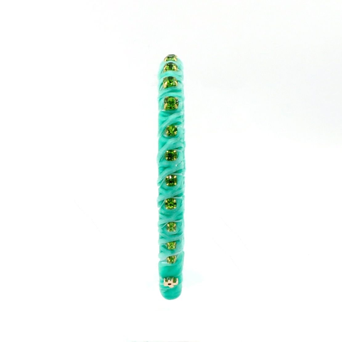 A single turquoise ribbed silicone bangle bracelet with small gold foil star accents, shown vertically on a plain white background.