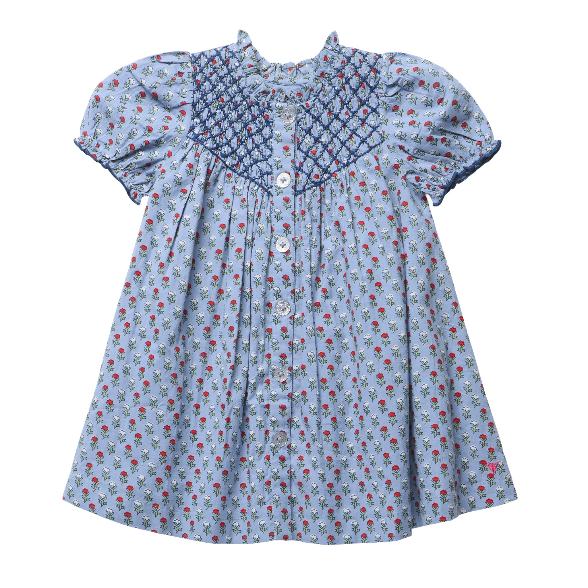 A light blue cotton dress for toddlers or girls, featuring a small red and white carnation print, a smocked blue yoke with white buttons, and short puff sleeves.