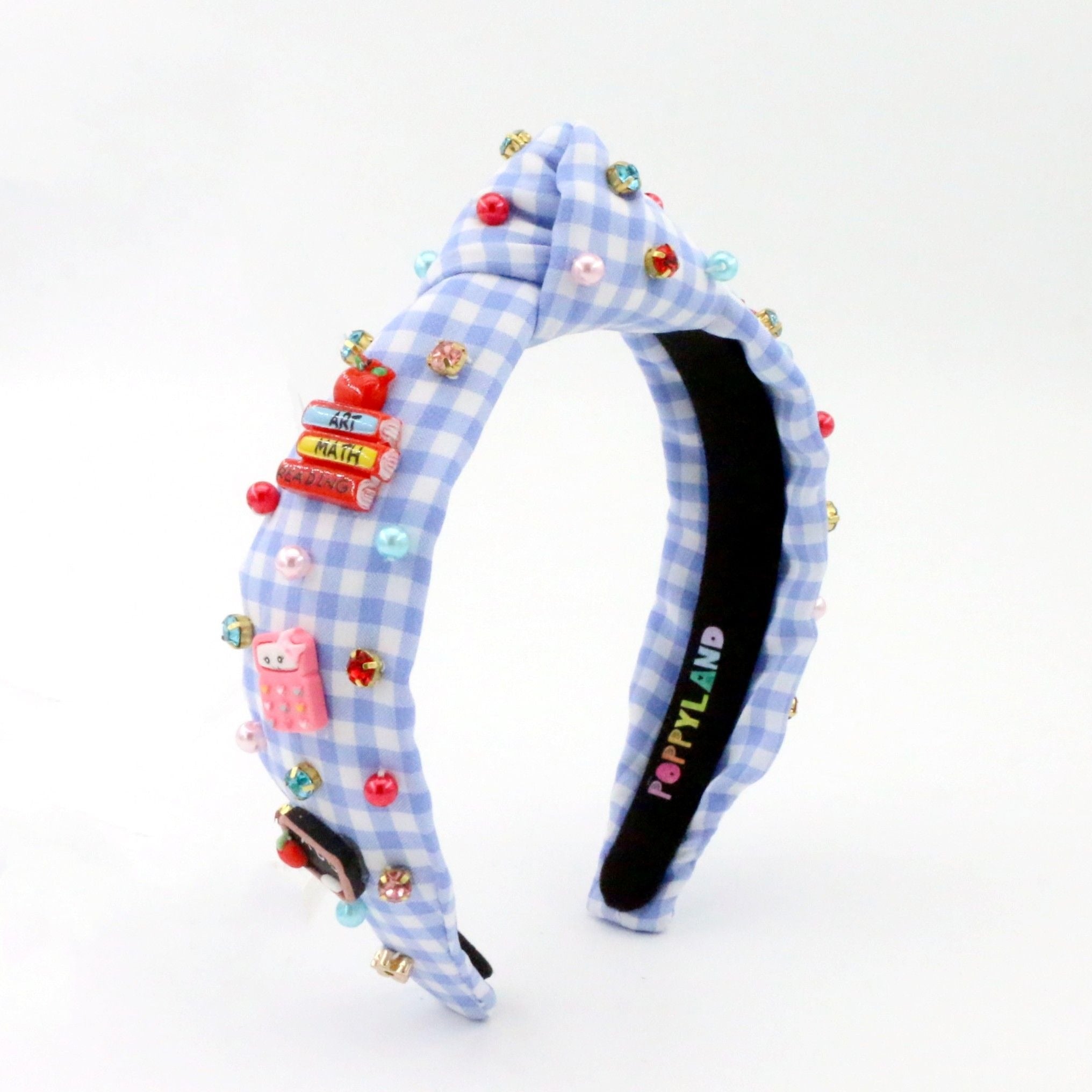 School themed headband with checkered pattern and colorful embellishments on a white background