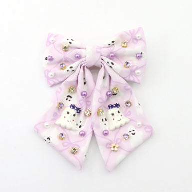 A light purple and white hair bow decorated with small rhinestones, pearl-like beads, and cute Halloween ghosts on a plain white background.