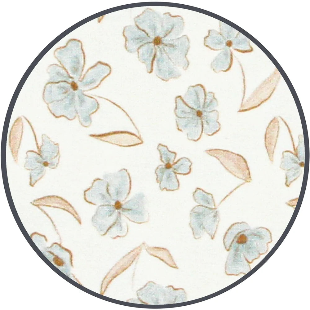 A circular fabric sample featuring a delicate floral pattern with light blue flowers and soft tan leaves on an off-white background, finished with a dark gray border.