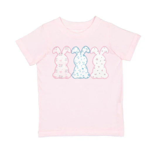 Pink t-shirt with colorful bunny design on a white background