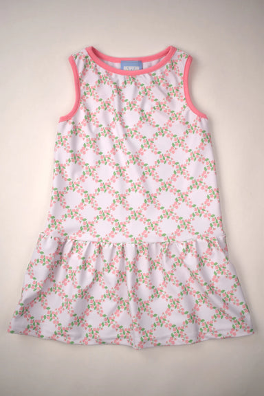 White dress with pink floral pattern on a beige background