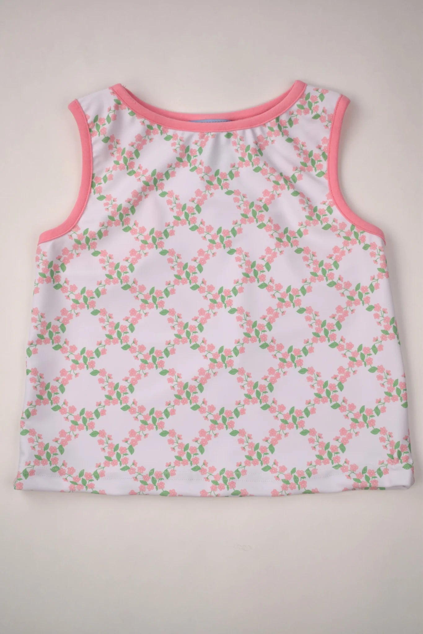Sleeveless top with floral pattern on a beige background