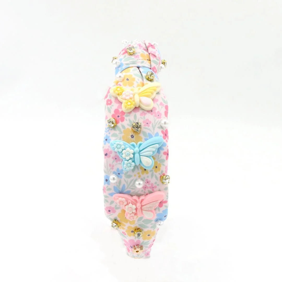 Decorative headband with colorful butterflies and flowers on a white background