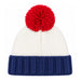 A knit beanie hat with a large red pom-pom on top, featuring a white knit crown and a navy blue ribbed cuff, shown against a plain white background.