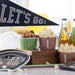 Sports-themed snacks and drinks with 'Let's Go!' banner and decor on a table.