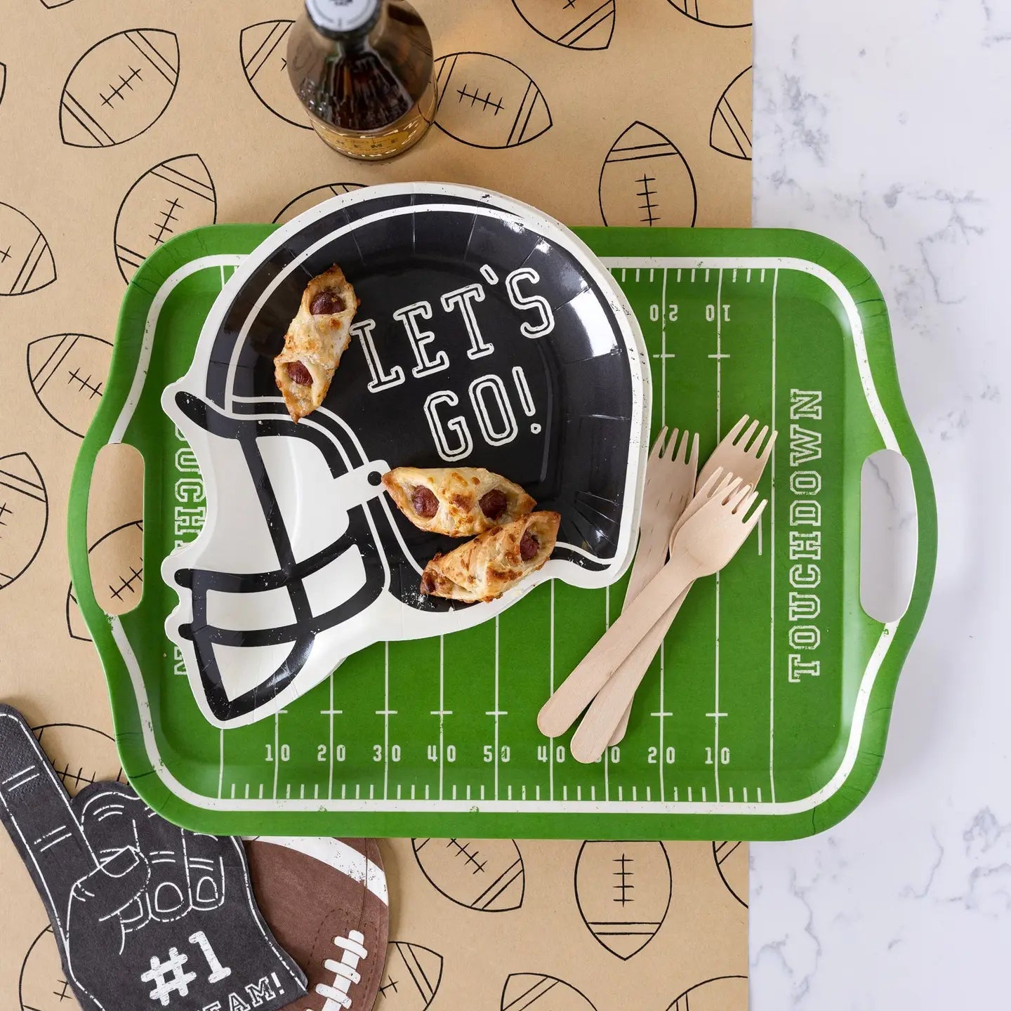 Green tray with football helmet design and 'Let's Go!' text, placed on a surface with football-themed decor.