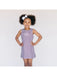 Young girl wearing a checkered dress with a white background