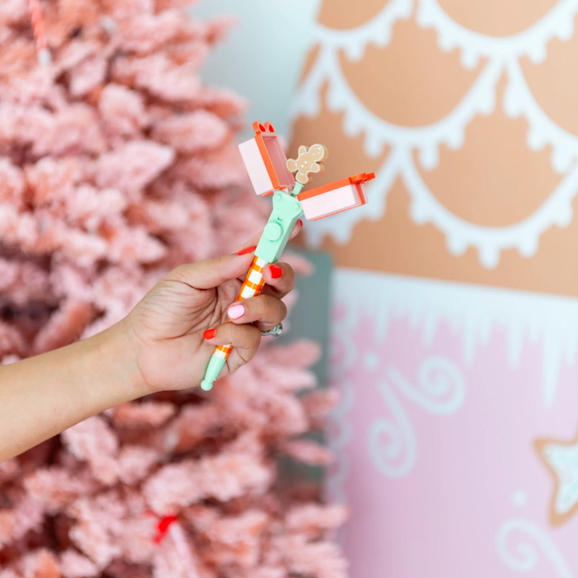 Hand holding a colorful toy with a decorative background