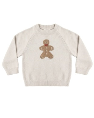 A cream-colored knit crewneck sweater featuring a brown gingerbread man graphic on the chest, displayed against a plain white background.