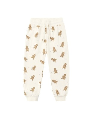 Cream-colored sweatpants with gingerbread pattern on a white background