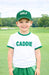 Child wearing a 'Golf Caddie' outfit on a golf course