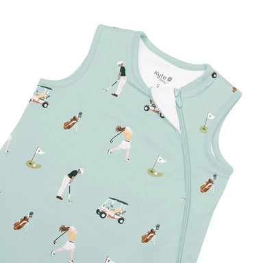 A sleeveless baby sleep sack in mint green, featuring an all-over golf-themed print with illustrated golfers, carts, and flags. The brand name 'Kylie Baby' is visible on the inner neck label.