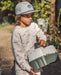 A boy wearing a fish snapback hat