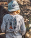 A boy wearing a fish snapback hat
