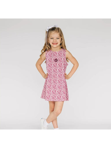 Young girl wearing a maroon A&M dress on a white background