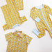 Children's clothing set with yellow and blue fish pattern on a white background