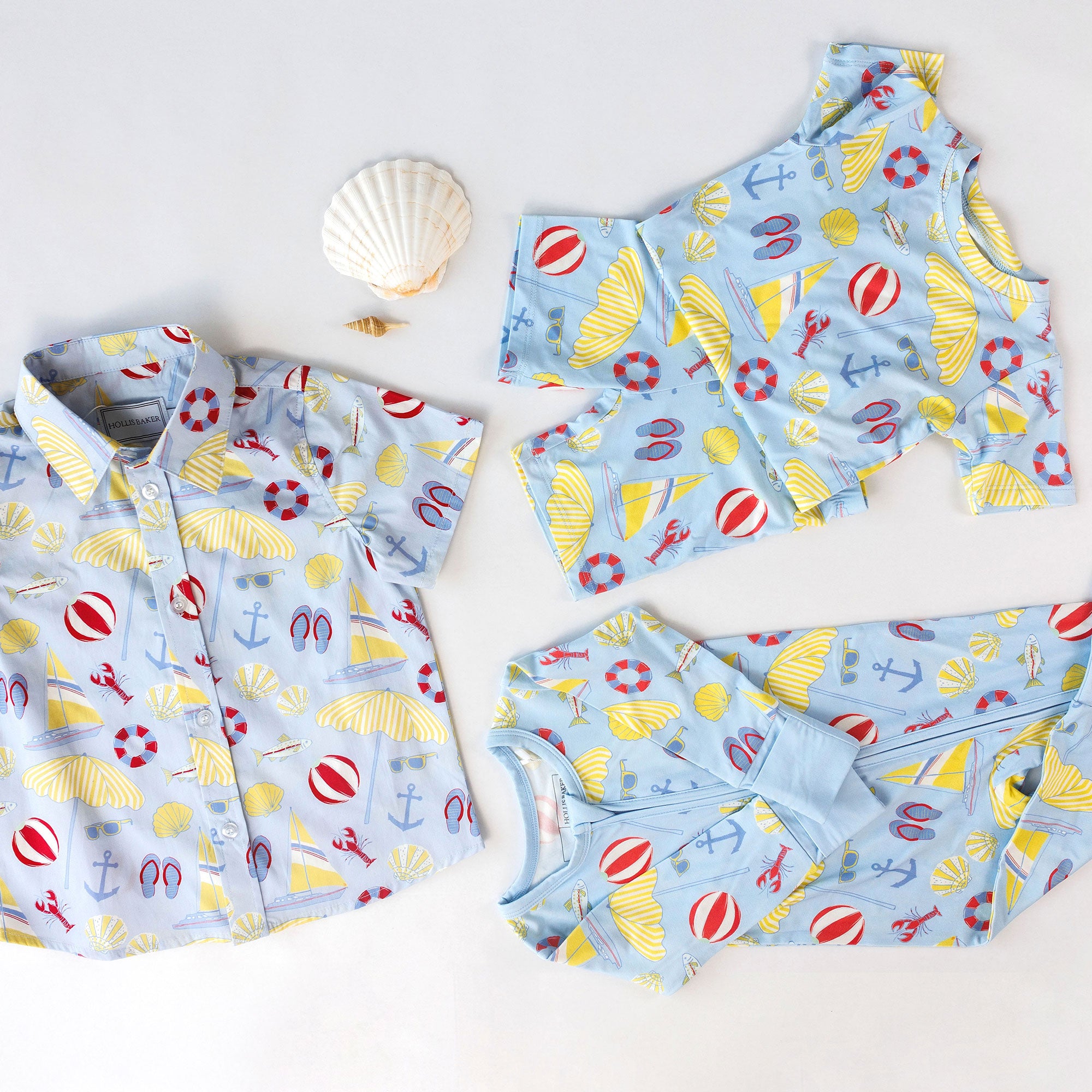 Children's clothing with beach-themed pattern on a white background