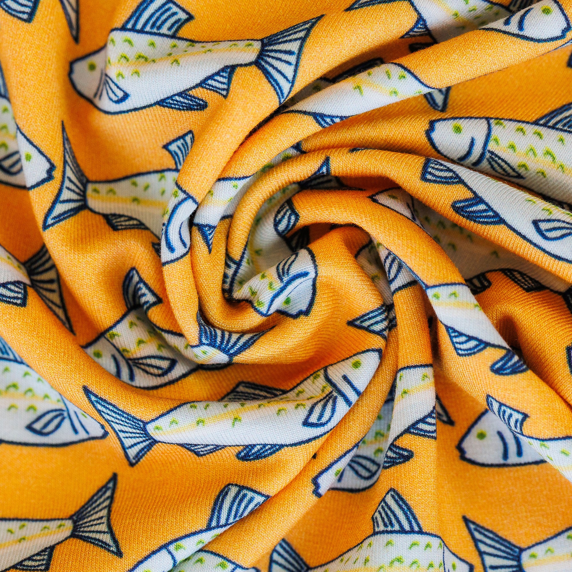 Close-up of orange fabric with fish pattern