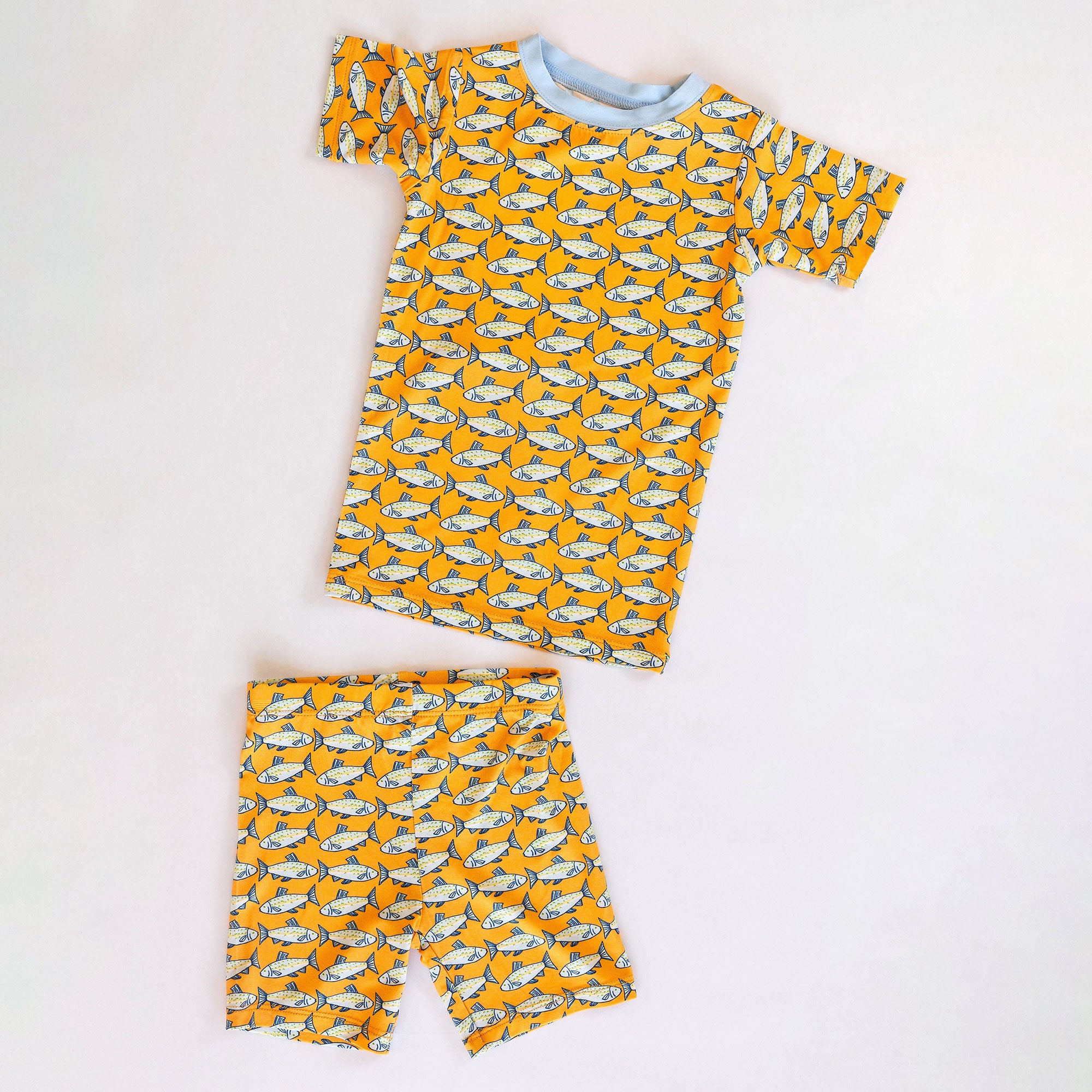 Children's pajama set with fish pattern on a white background