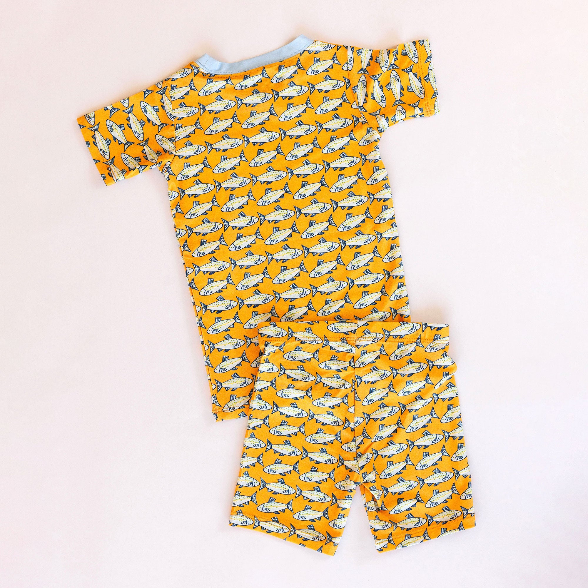 Children's pajama set with fish pattern on a white background