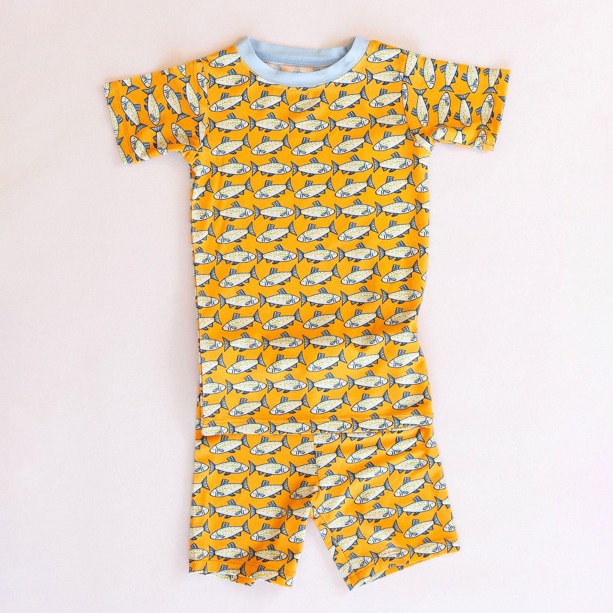 Children's loungewear set with fish pattern on a plain background