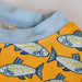 Close-up of a fabric with fish pattern on yellow background