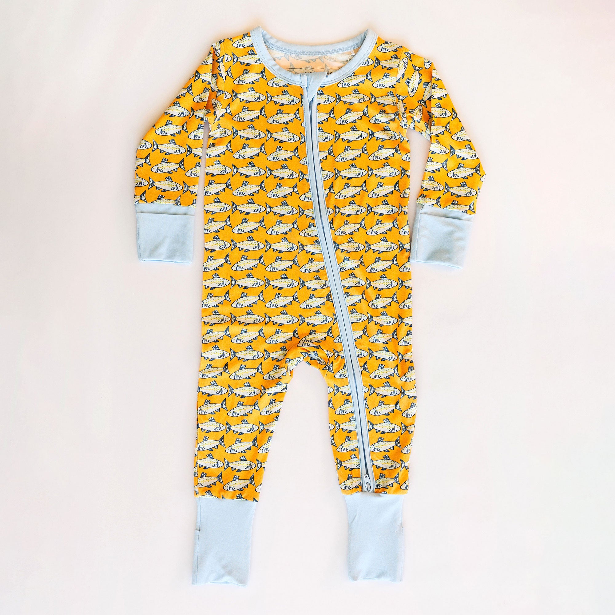 Baby onesie with fish pattern on a white background
