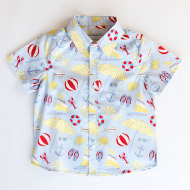 Children's shirt with beach-themed pattern on a white background